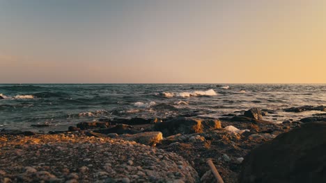 static view of ocean waves at a rocky beach