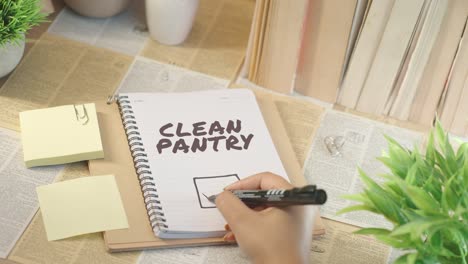 ticking off clean pantry from checklist