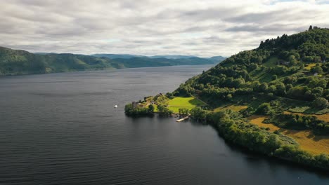 aerial shot of urquhart castle ruins on loch ness in inverness, scottish highlands, scotland