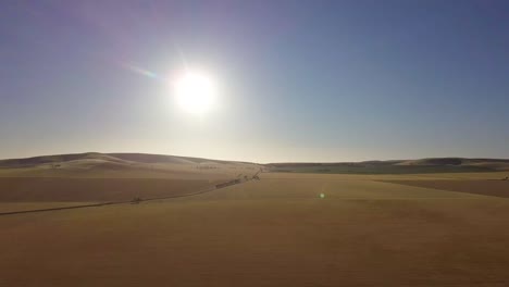 aerial shot of arid lands in the outback under a hot low sun, stuart highway, australia