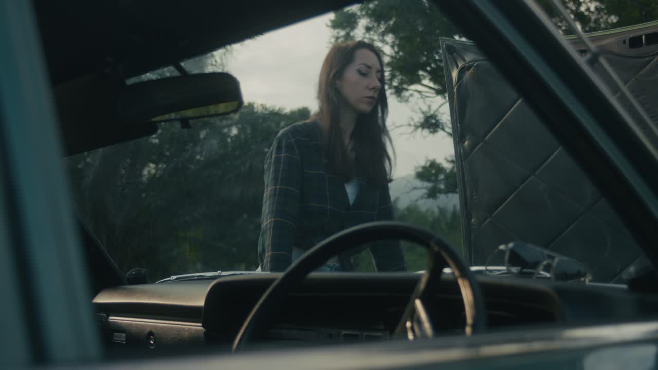Woman Checking Broken Down Car