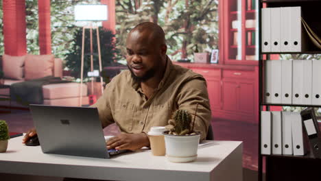 successful entrepreneur using his laptop for remote business operations