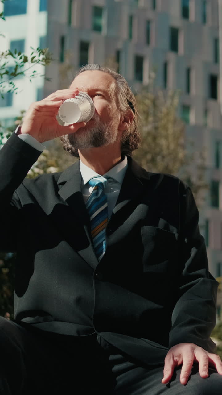 Businessman Enjoys Coffee Break in the City
