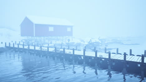 red house on a foggy winter day