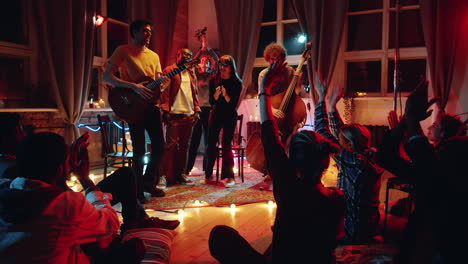 music band standing on stage to applause of fans on concert