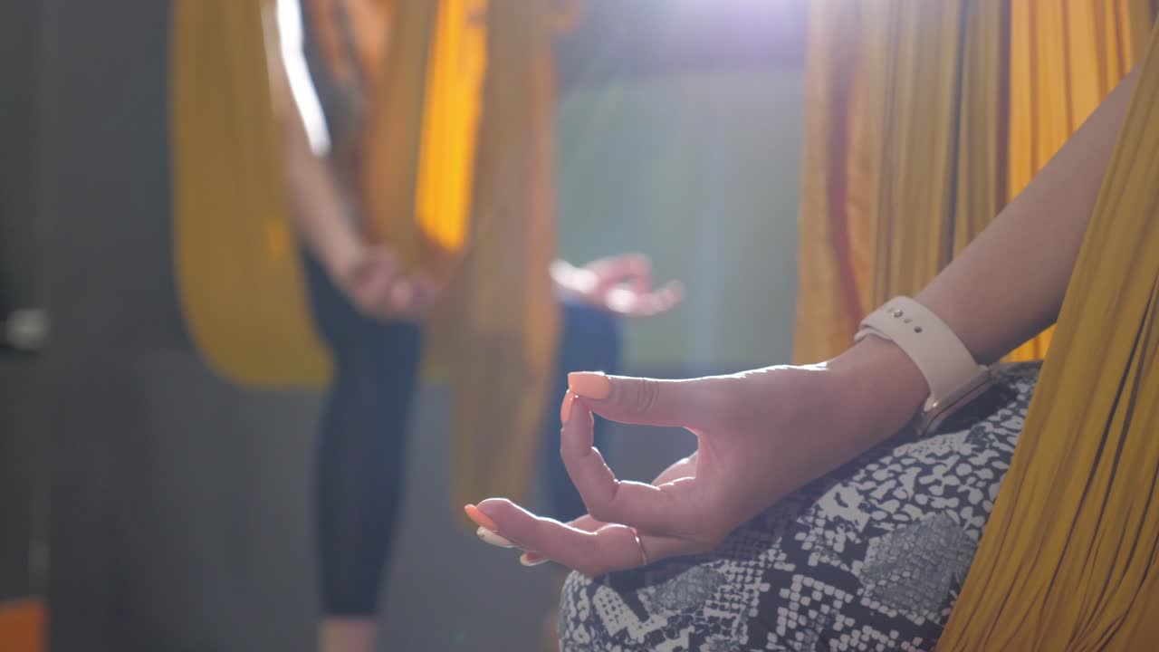 mujer practicando yoga aéreo