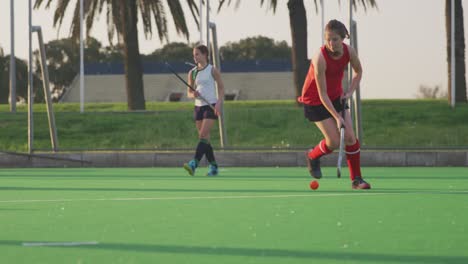 Female-hockey-players-playing-on-the-field