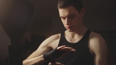 caucasian man wrapping hand for boxing training