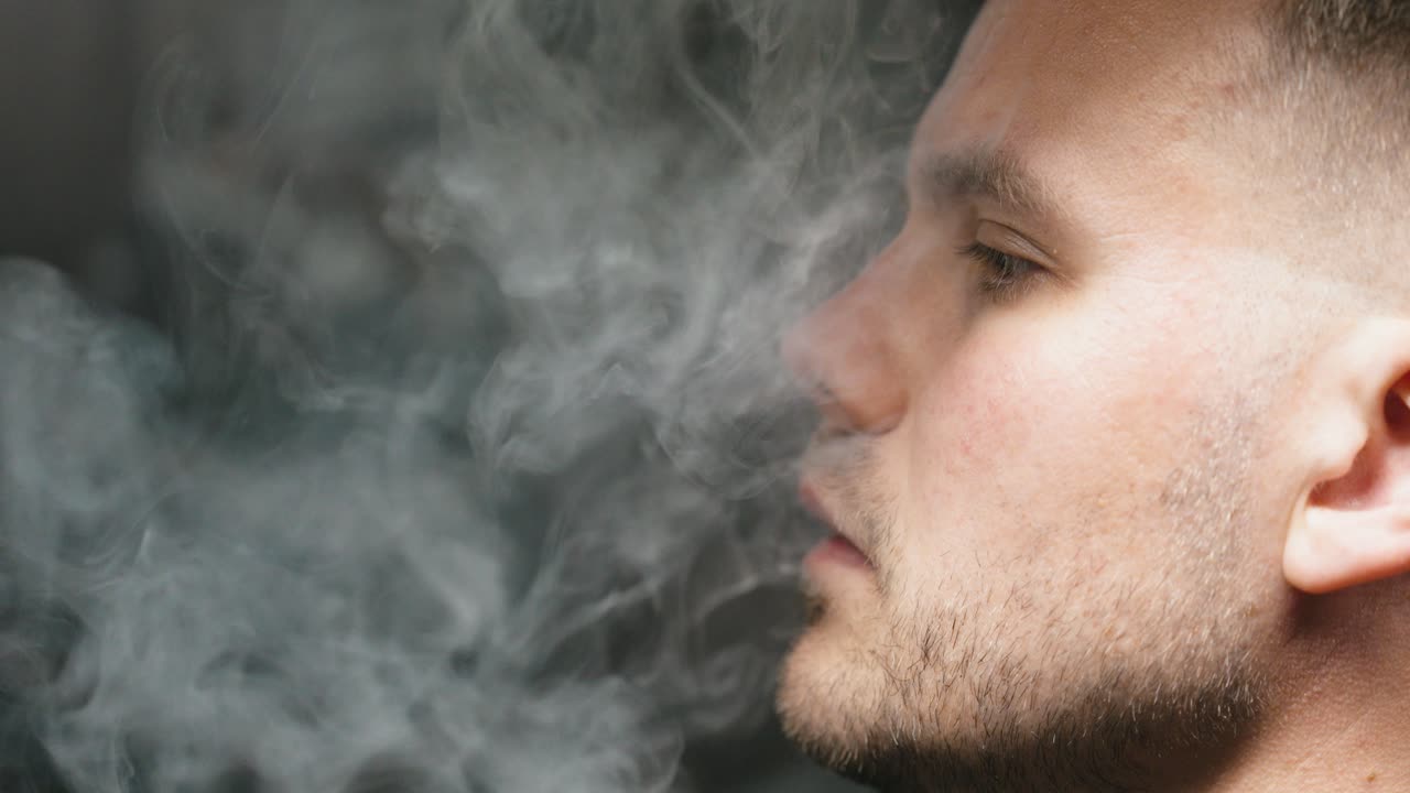 e-cigarette smoking or vaping filmed from the side