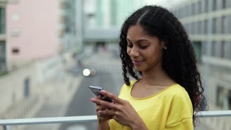 smiling woman texting by smartphone