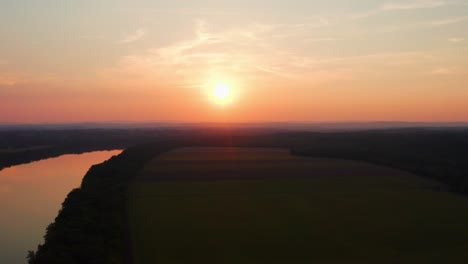 water reflects orange sunlight as the sun sets in maryland over the serene potomac river water