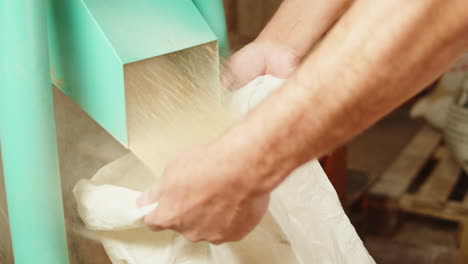 worker filling bags with flour from a mill