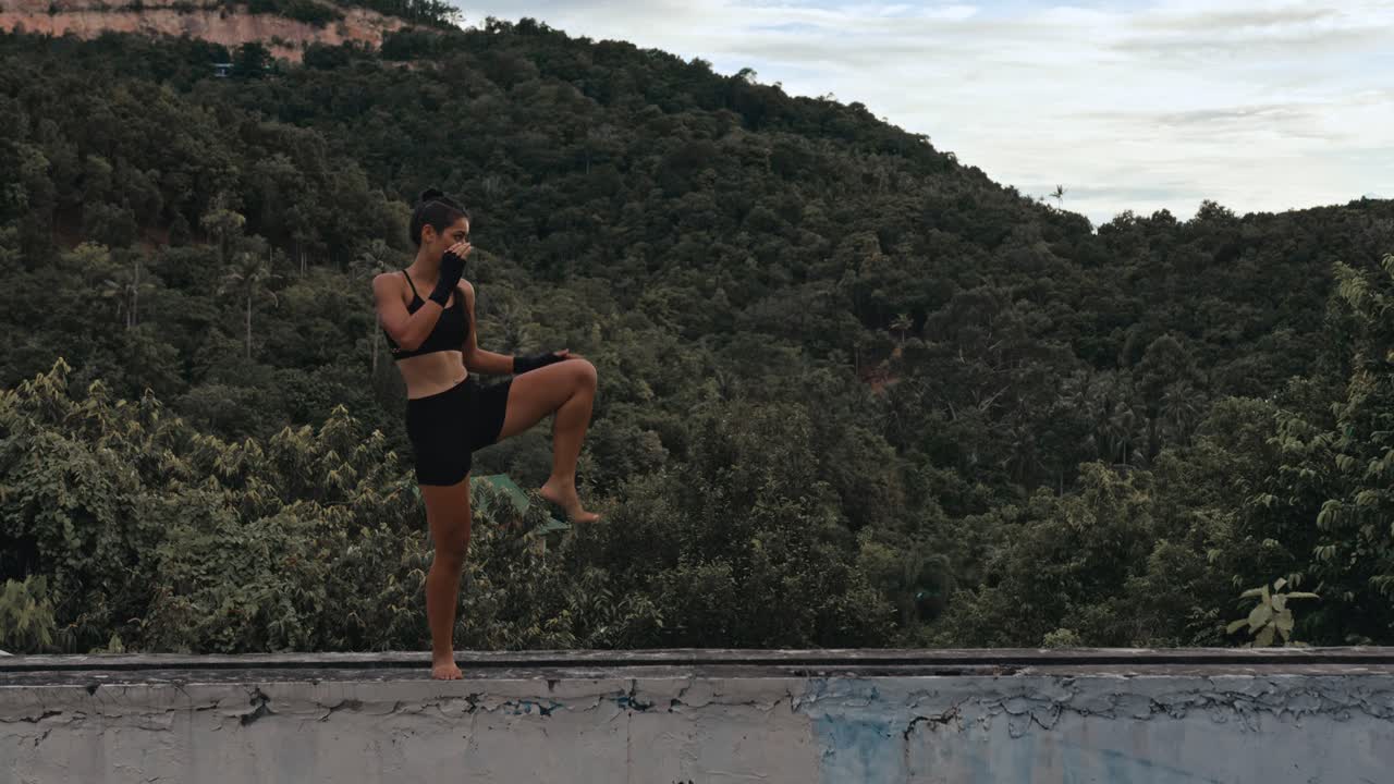 Woman practicing martial arts outdoors