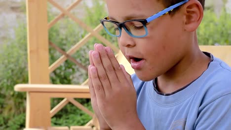 little boy praying to god with hands together stock footage