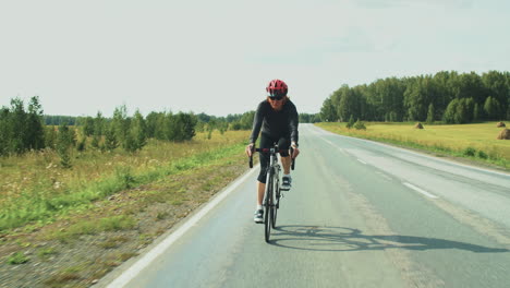 female triathlete riding bike on road