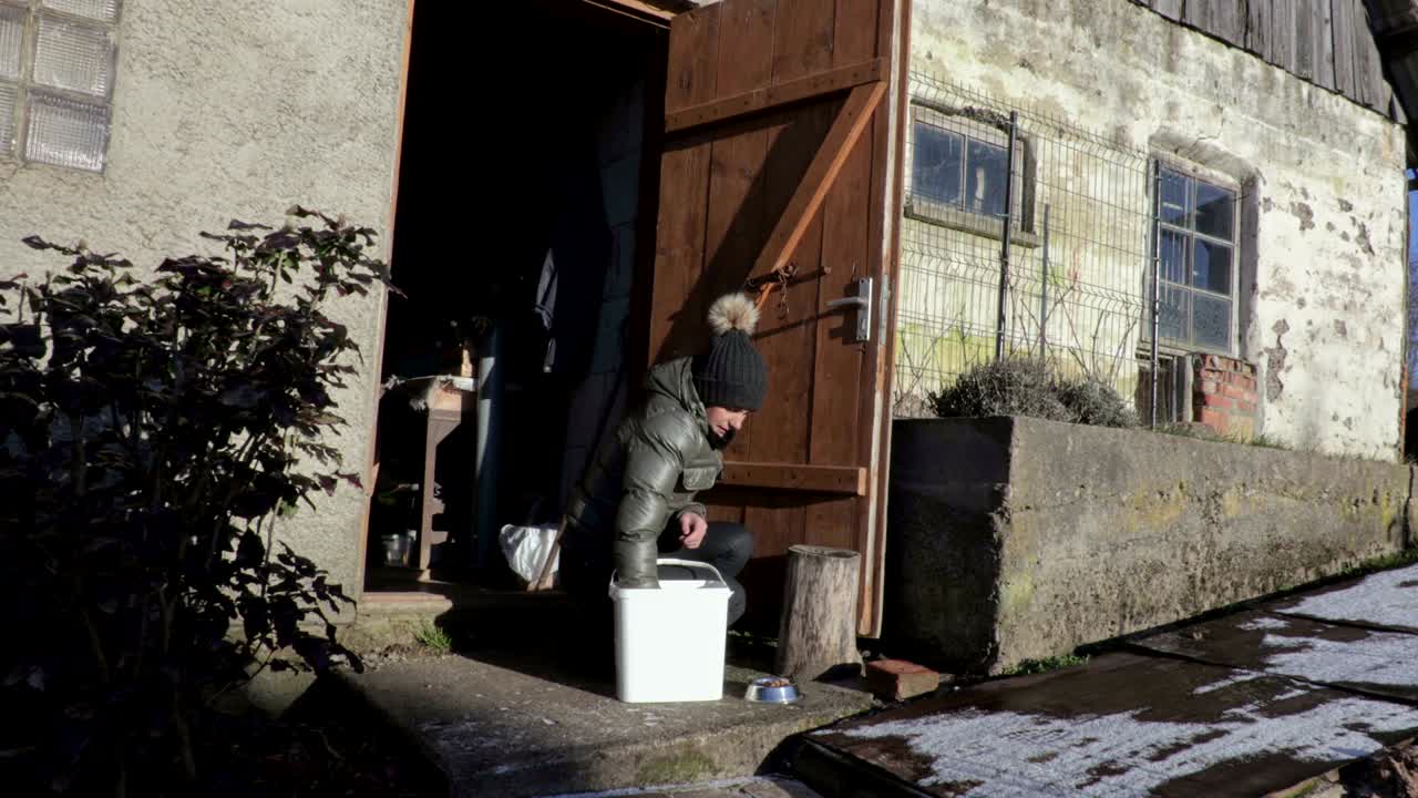 Woman put cat food in bowl and looking for cat