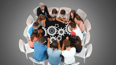 un grupo de personas en una mesa redonda y engranajes
