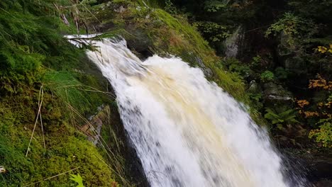 static close up view of beautiful gushing triberg waterfall during fall season day, schwarzwald, germany