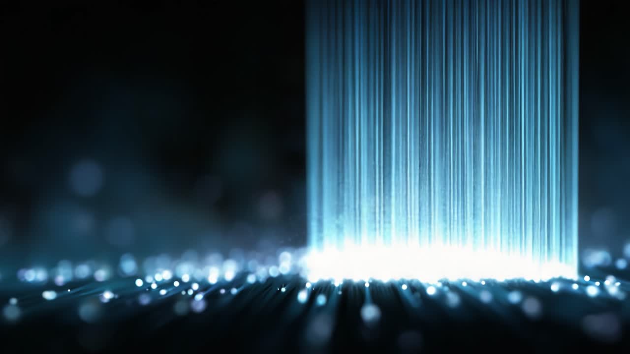 A mesmerizing display of light beams cascading downwards, illuminating a dark background with glimmering particles creating an enchanting visual experience