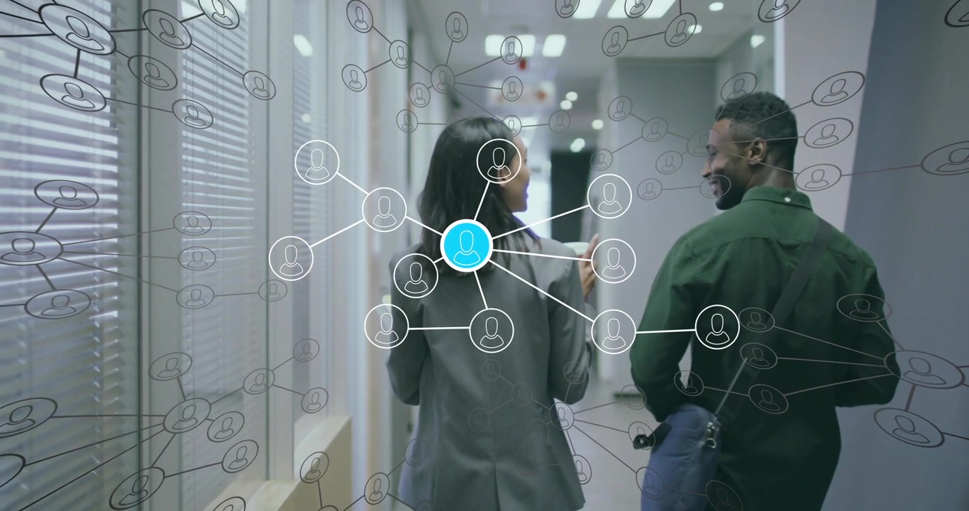 Two colleagues walking office corridor holding cups activating network overlay showing data links