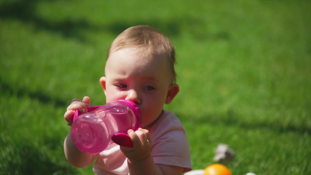 Baby drinking water outdoors
