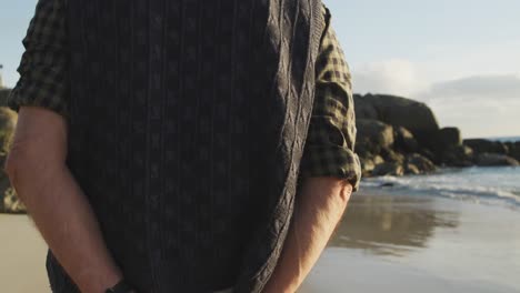 Vista-Trasera-De-Un-Hombre-Mayor-Caminando-Por-La-Playa.