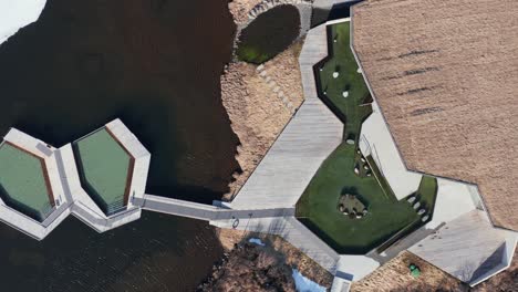 vã¶k infinity floating pool geothermal baths on sunny day, iceland, top down