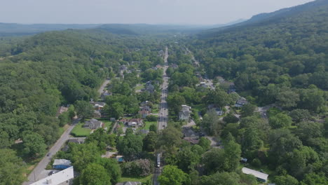 drone view looking down the full stretch of st. elmo avenue as it cuts through chattanooga’s wooded foothills