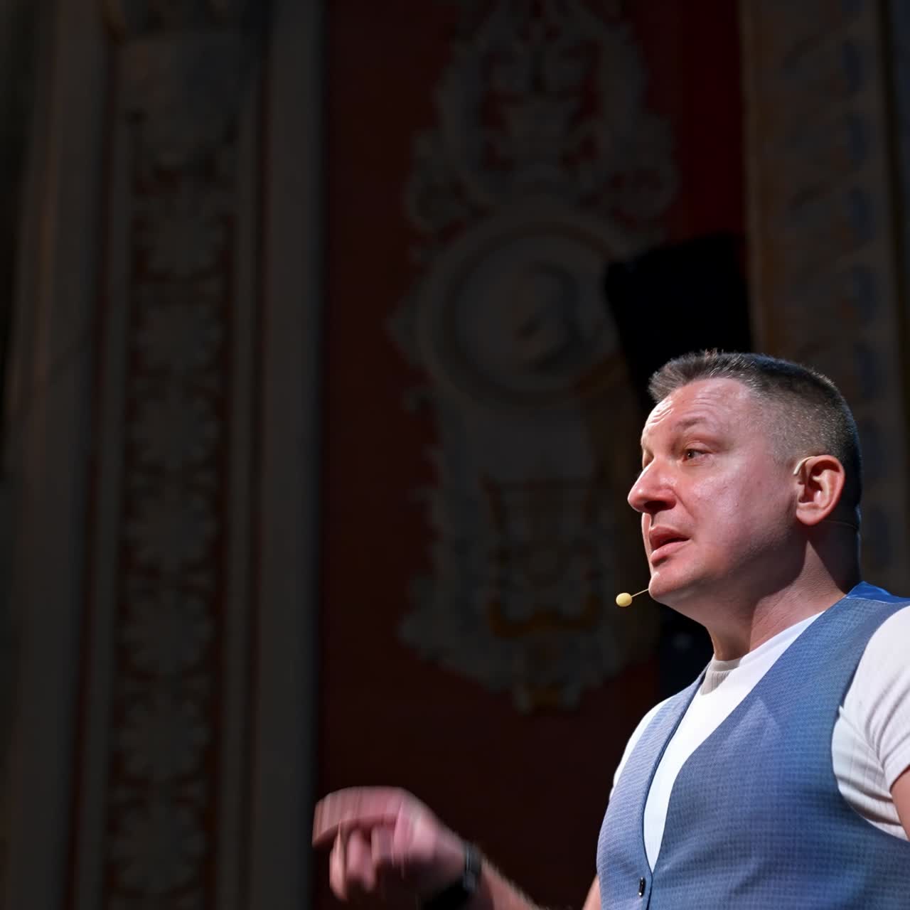 Speaker perform a monologue on stage. Professional actor on stage speaking and gesticulating in theater