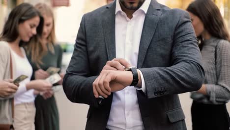 a confident businessman checks his watch, surrounded by others engaged in transactions in an urban setting, capturing moments of modern lifestyle and commerce