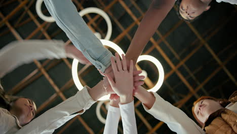 diverse group of people joining hands in teamwork and collaboration