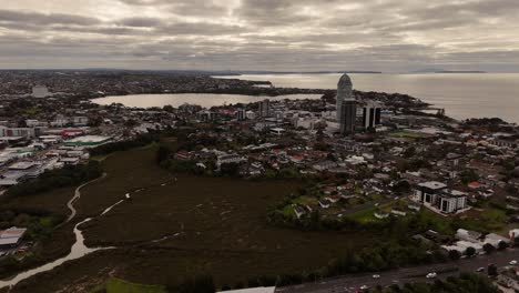 a stunning 4k 60fps aerial shot of takapuna, a vibrant coastal suburb in auckland. the footage showcases the famous beach, the town centre, and the iconic view of rangitoto island in the hauraki gulf