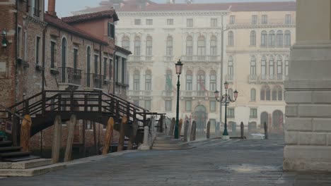 foggy venetian alley and bridge at dawn, italy