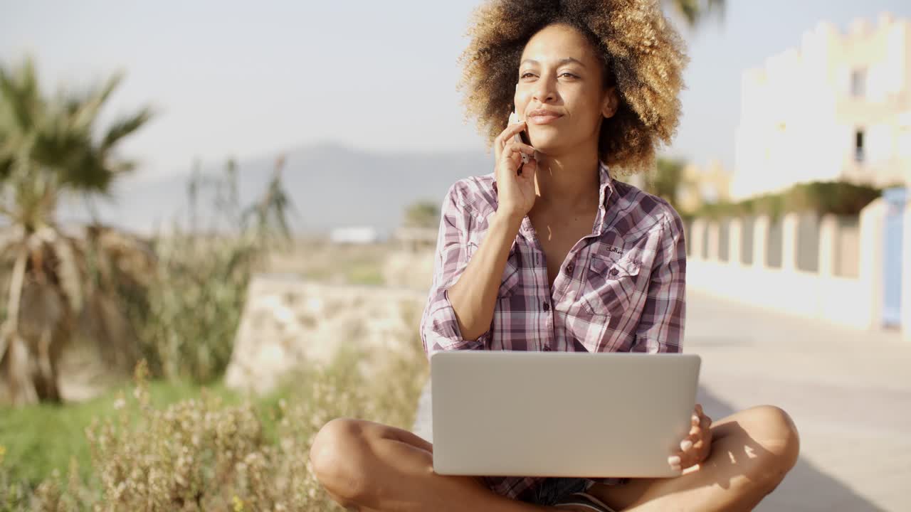 Young African Woman Working On Laptop In Nature.