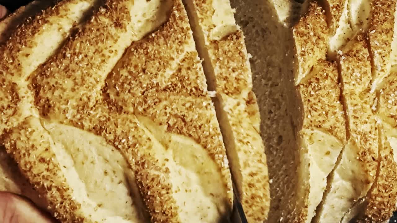 Serrated kitchen knife, food preparation, freshly homemade tasty bread