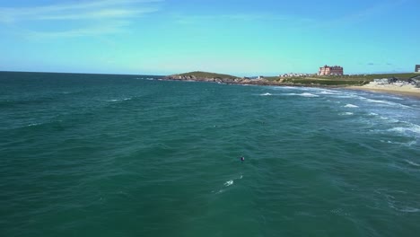 surfers getting ready to catch a wave in cornwall