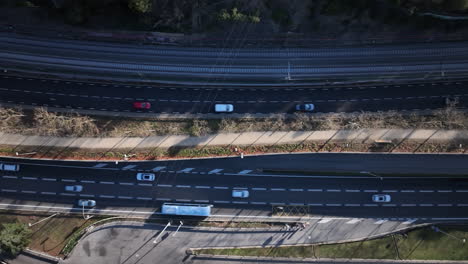 Cars-driving-on-local-highway-in-Spain,-aerial-top-down-view