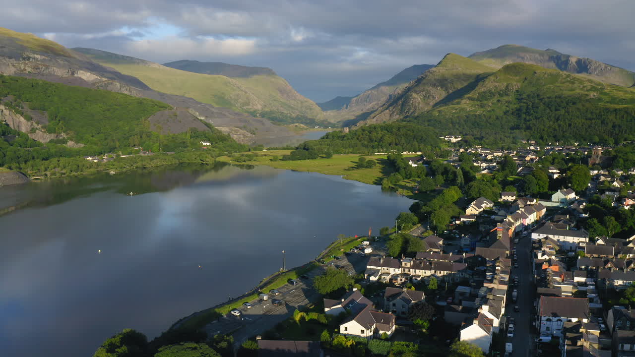 Sprawling Lush Green Landscape And A Provincial Village in Snowdonia Wales UK - aerial shot of Llanberis