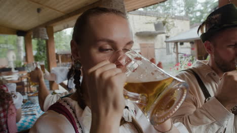 people in traditional clothing celebrating oktoberfest with beer