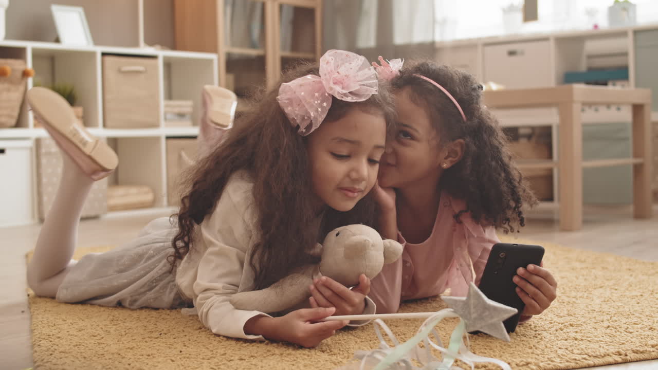 Little Sisters Whispering in Ears