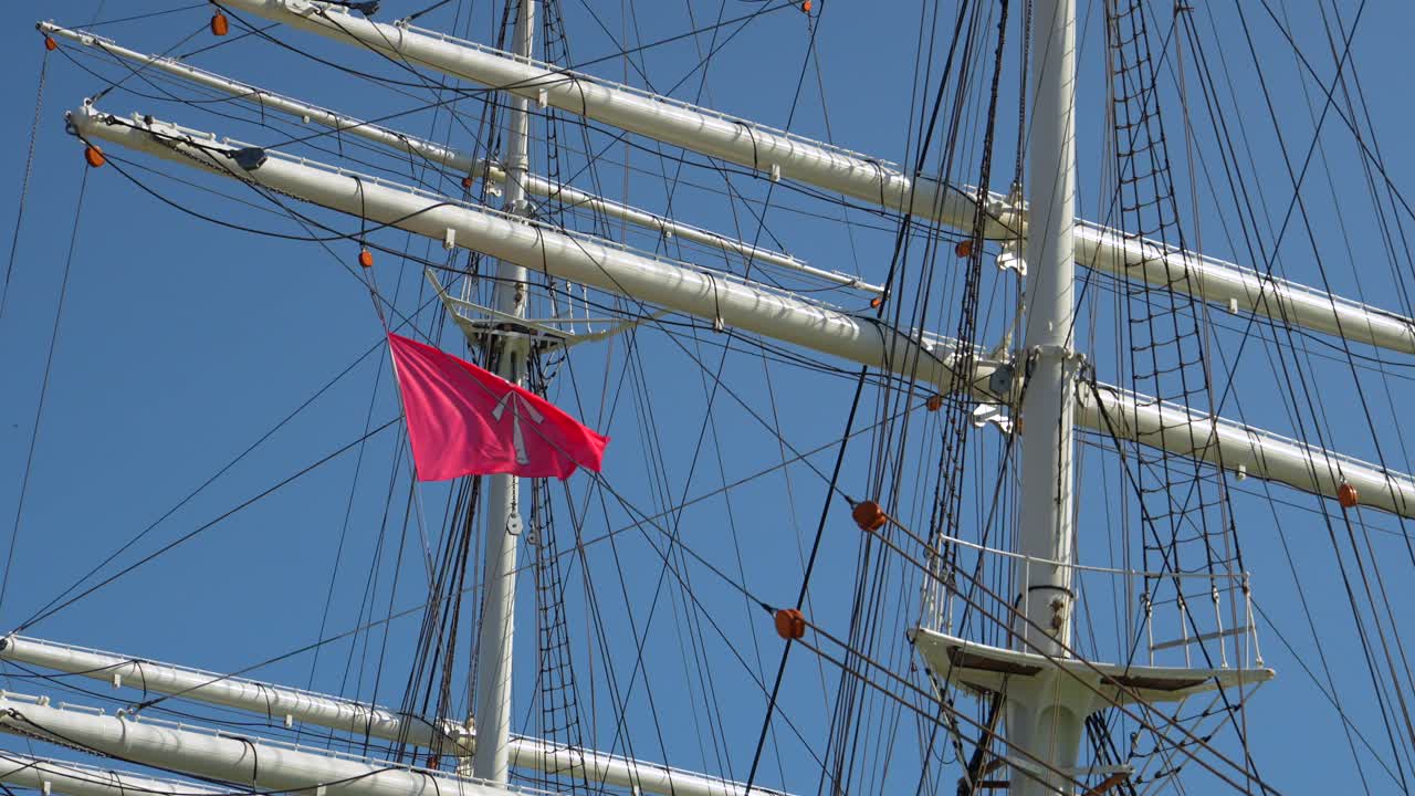 close shot ship mast white sailboat with stralsund flag on sunny day