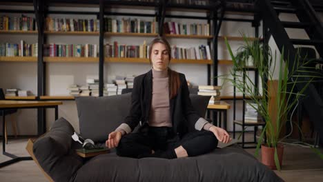 woman meditating in a home office