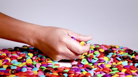 hands interacting with vibrant candy assortment