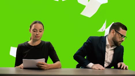 young beautiful tv presenter and stylish young man are hosting a news tv channel. the young man gets angry, throws the papers and leaves the frame. chromakey.