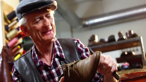 shoemaker repairing a shoe