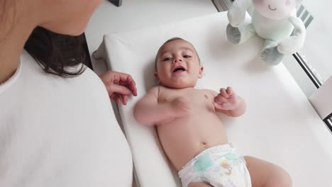 joyful mother and little baby at home