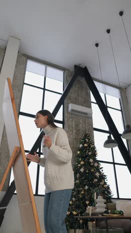 woman looking at a board in a decorated living room