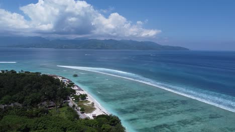 stunning aerial view of tropical beach with turquoise ocean and distant mountains