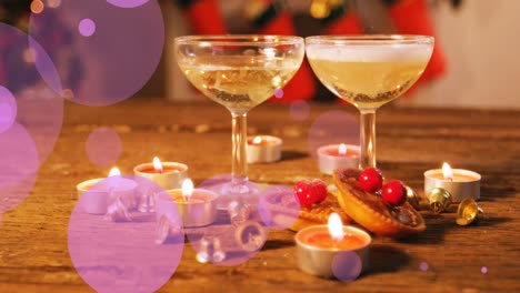 Animation-of-violet-dots-moving-over-glasses-with-wine-and-tealights
