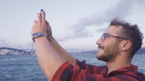 Saving-the-Bosphorus-view-from-the-ferry-to-the-phone.-Istanbul-city.